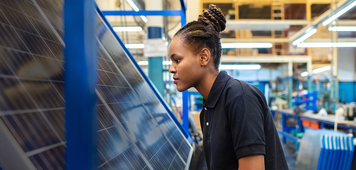 Woman working in solar panel factory