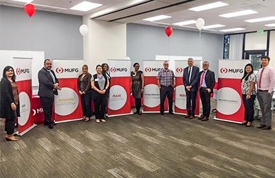 MUFG Employees standing in front of Enterprise Group Logo Banners.