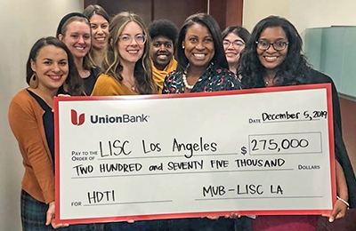 Group of women holding large $275,000 check made out to LISC Los Angeles