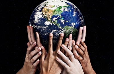 Globe being held by many hands