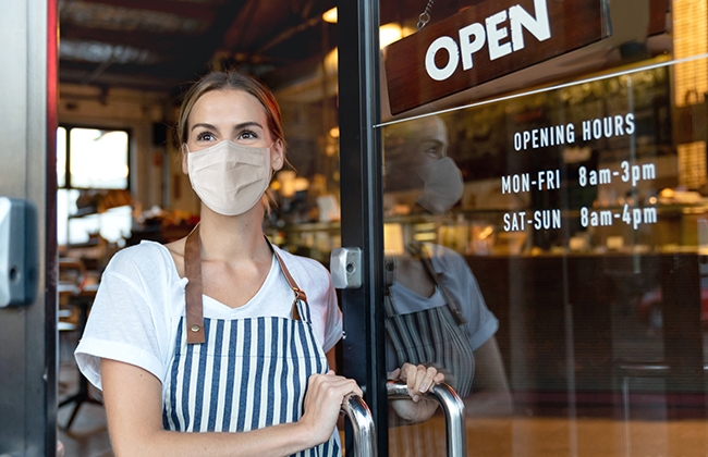 Restaurant worker standing in doorway