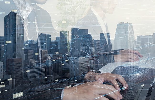 Reflection of people working in a window overlooking the city