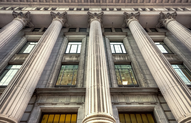 Image looking up the pillars of a bank