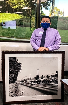 Man with a framed black and white picture.