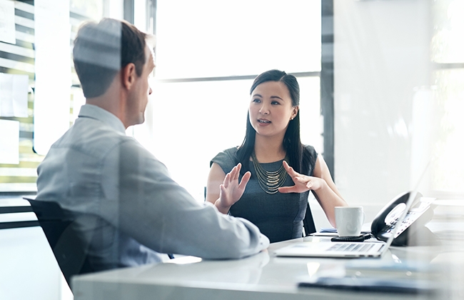 Woman discussing business with man