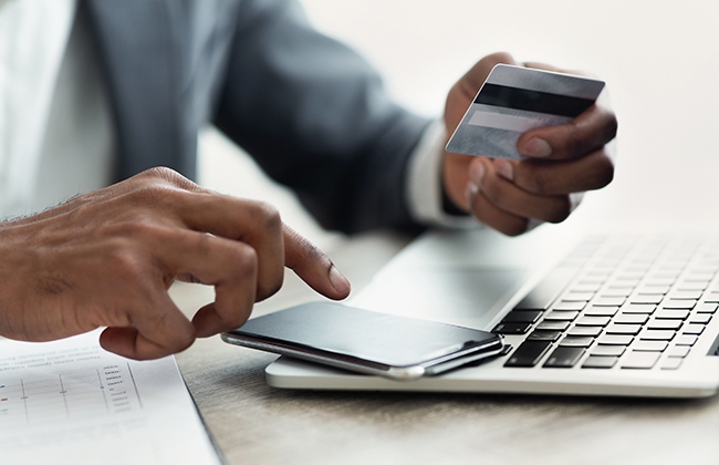 Man with a credit card and calculator 