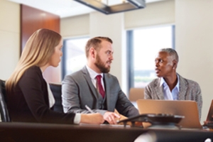 Image of business people looking at computer. 