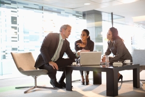 Image of business people looking at computer. 