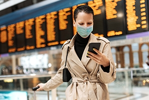 Woman traveling and holding her phone