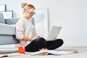 Woman sitting on floor with laptop