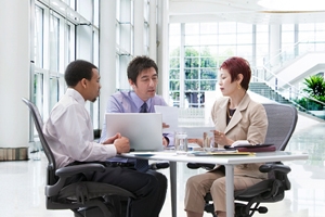 Image of 3 people sitting at a table.