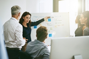 Image of someone presenting on a white board. 