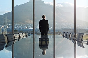 Man in conference room looking at view from the window